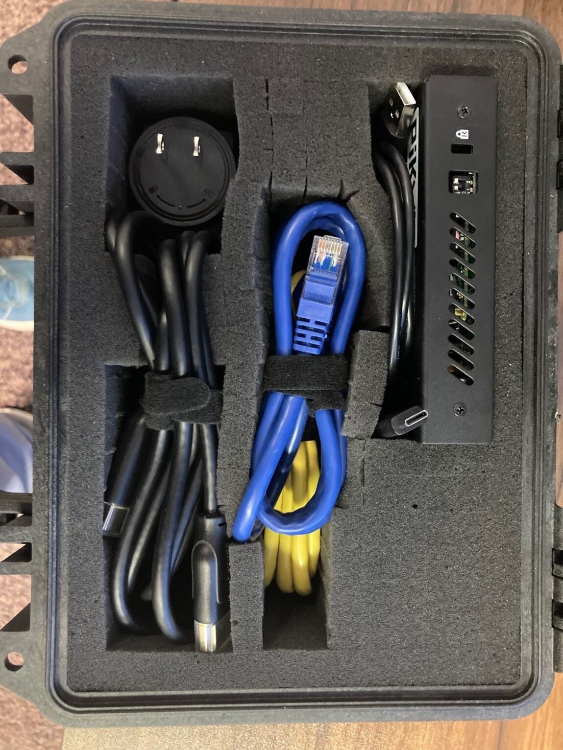 A black box with wires inside

Description automatically generated